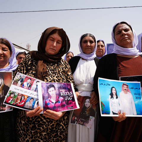 August 1, 2025, Zakho, Iraq: Iraqi Yazidi women hold pictures of their victims and missing relatives during a ceremony at Chamishko camp for Yazidi IDPs