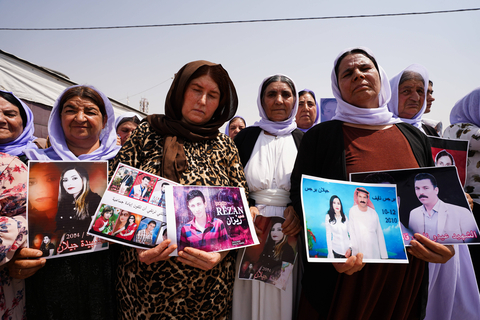 August 1, 2025, Zakho, Iraq: Iraqi Yazidi women hold pictures of their victims and missing relatives during a ceremony at Chamishko camp for Yazidi IDPs