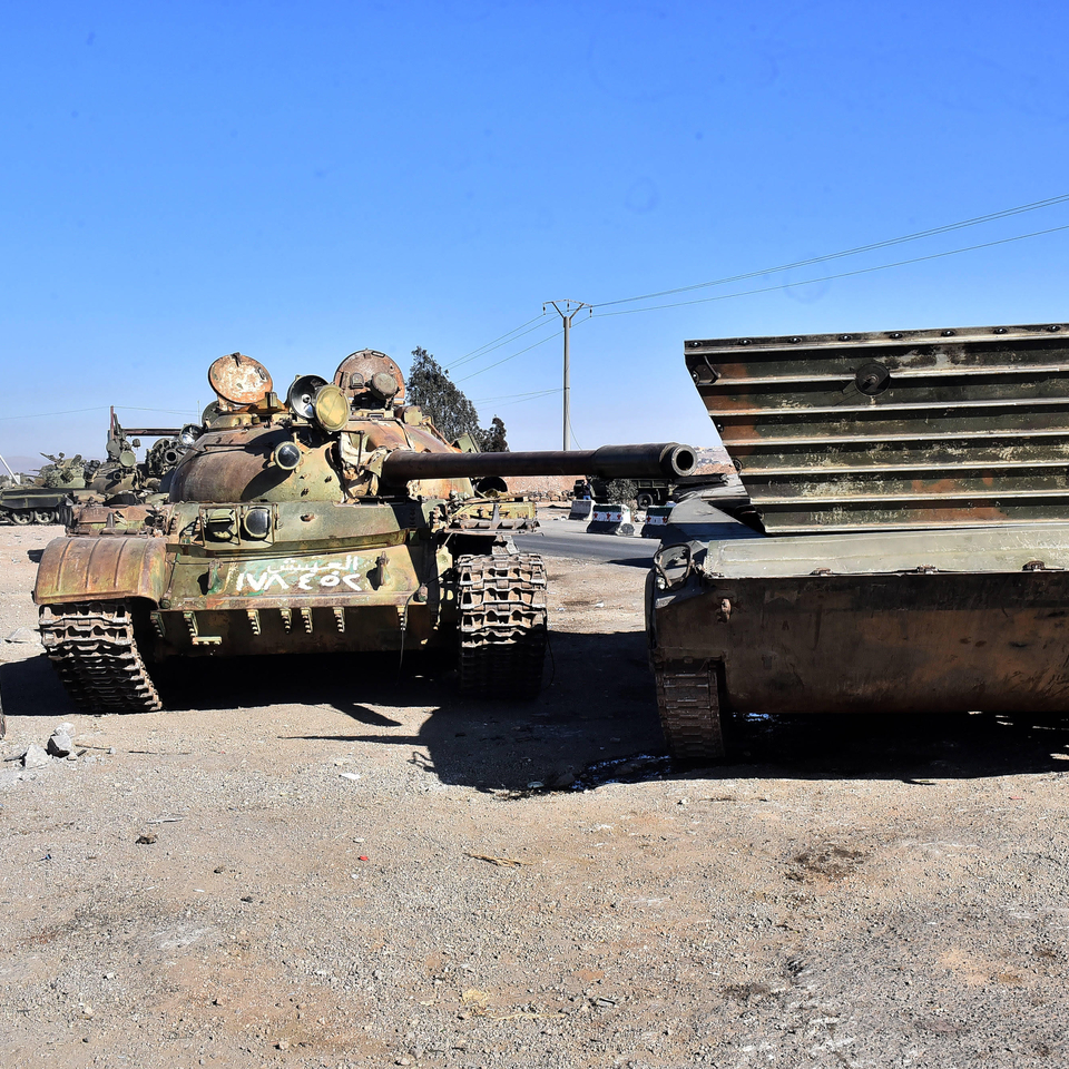 Tanks and abandoned military vehicles, while spread opposition fighters spread