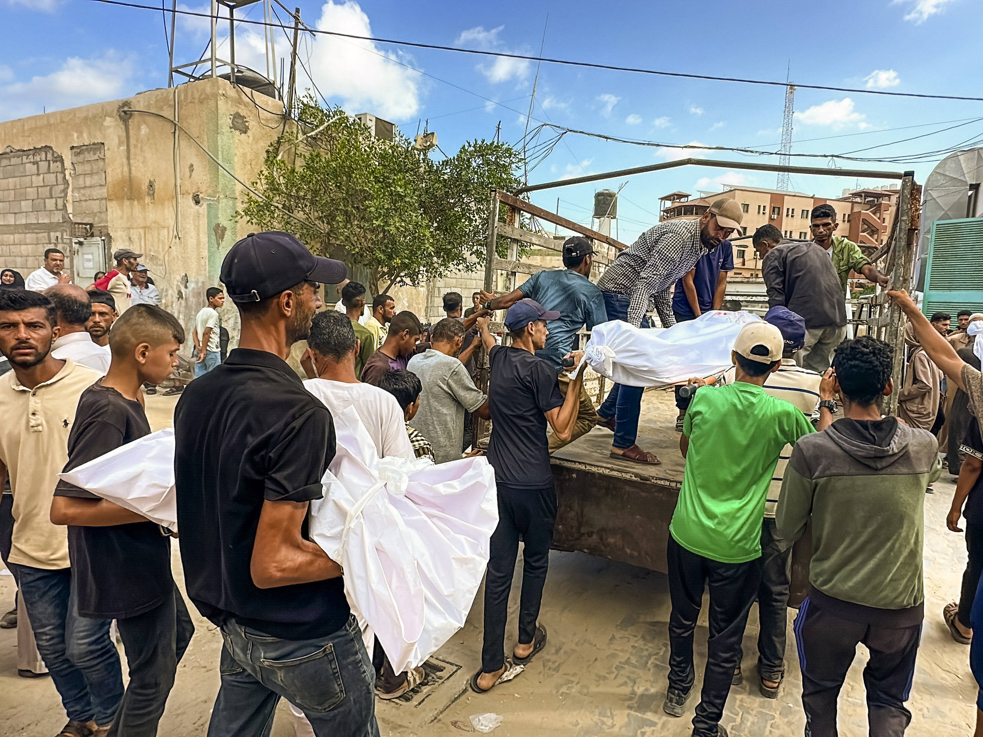 Mourners Grieve Gaza Aid and Shelter Victims Palestinians mourn over the bodies of victims killed in airstrikes during a funeral in Rafah in the southern Gaza Strip on July 31, 2025. Eighteen people were killed while waiting for humanitarian aid at a US aid distribution point in the Morag area of Rafah, according to local health officials. In a separate strike, six Palestinians were killed when a tent housing displaced persons was hit in the Mawasi area of Khan Yunis.