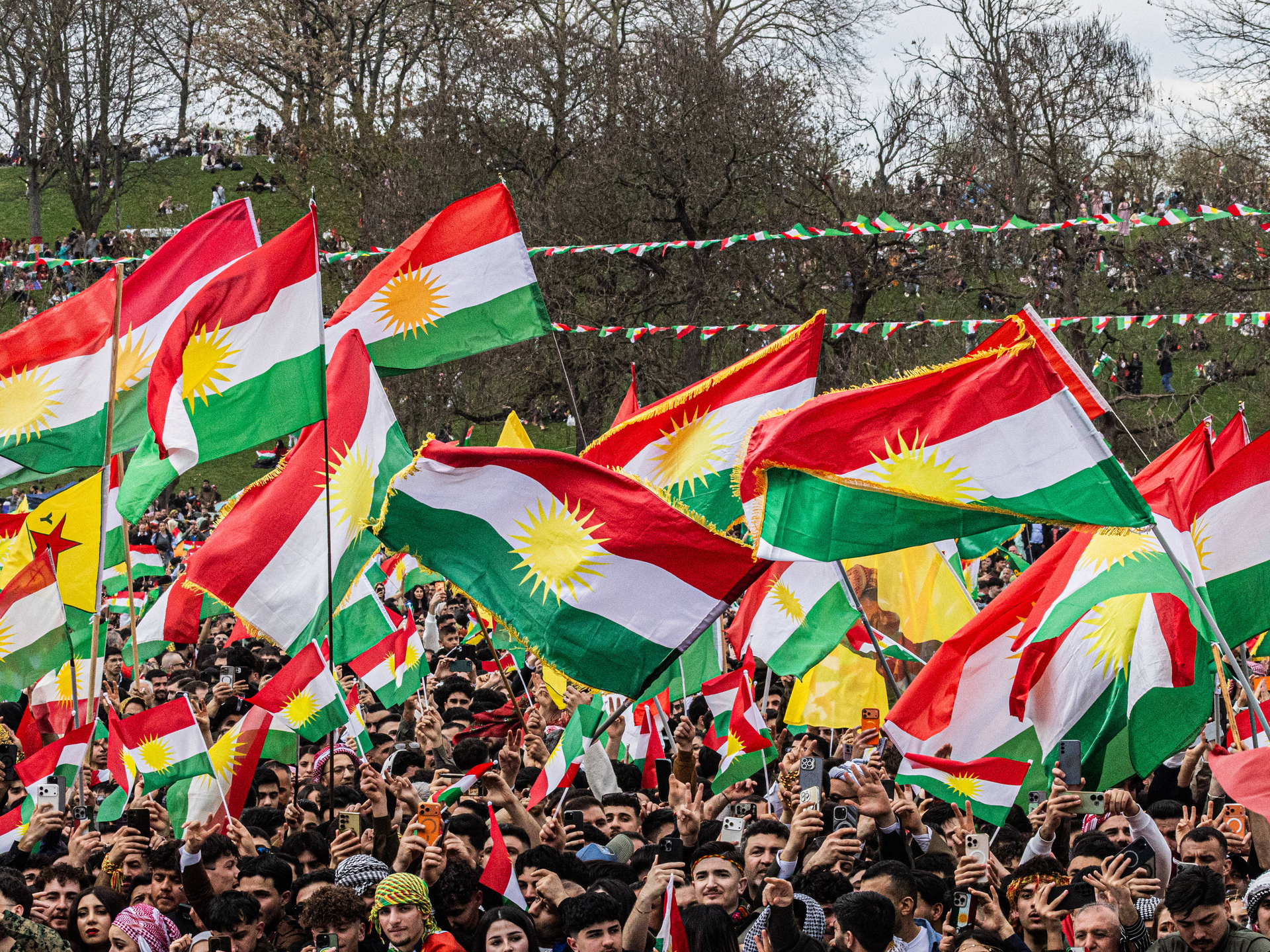 Kurds demonstrate with the flag of Kurdistan (also called Ala Rengin) on Saturday (March 23, 2026) in the Rheinaue park in Bonn for their own state of Kurdistan and celebrate the New Year and spring festival of Newroz. 